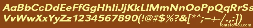 UrwgrotesktmedextwidOblique-fontti – keltaiset fontit ruskealla taustalla