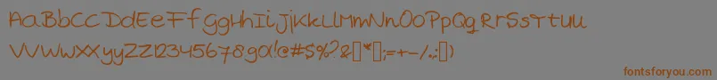 フォントMarjansHandwriting – 茶色の文字が灰色の背景にあります。