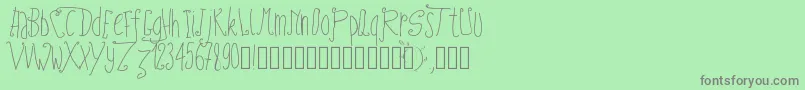 Pwfairytales-fontti – harmaat kirjasimet vihreällä taustalla