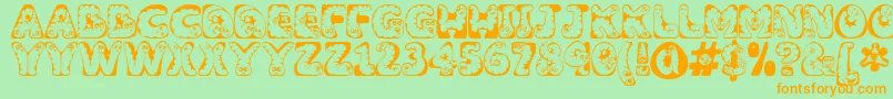 Wiggles-Schriftart – Orangefarbene Schriften auf grünem Hintergrund