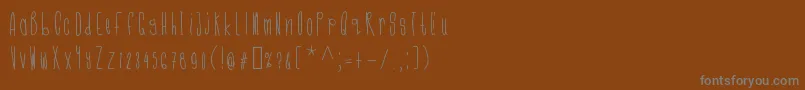 Cmonkeeregular-Schriftart – Graue Schriften auf braunem Hintergrund