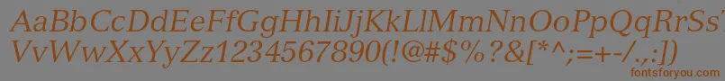 フォントVersaillesltstdItalic – 茶色の文字が灰色の背景にあります。