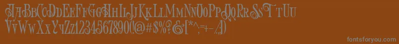 フォントArtVictorian – 茶色の背景に灰色の文字