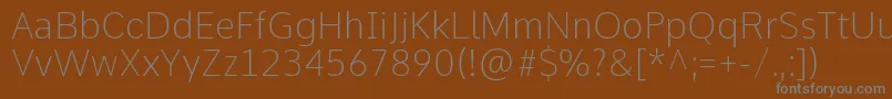 CommeThin-Schriftart – Graue Schriften auf braunem Hintergrund