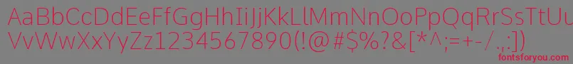 CommeThin-Schriftart – Rote Schriften auf grauem Hintergrund