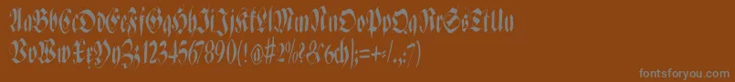Zenfraxfreestylecondensed-fontti – harmaat kirjasimet ruskealla taustalla