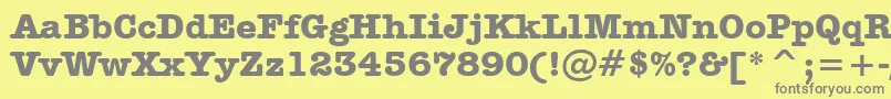 AmericanTypewriterBoldBt-fontti – harmaat kirjasimet keltaisella taustalla