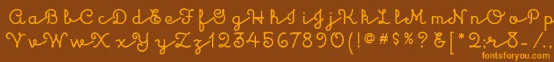フォントKulukundisitcTt – オレンジ色の文字が茶色の背景にあります。