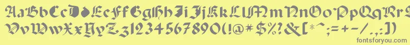 フォントCapinini – 黄色の背景に灰色の文字