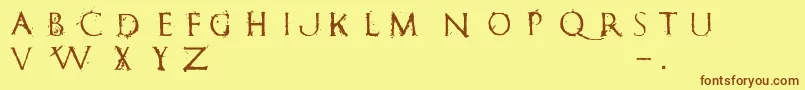 フォントRomanumEst – 茶色の文字が黄色の背景にあります。
