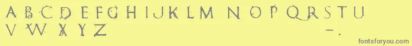 フォントRomanumEst – 黄色の背景に灰色の文字