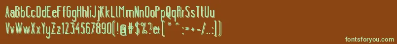 フォントYgraineShadow – 緑色の文字が茶色の背景にあります。