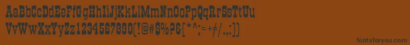 フォントGradc – 黒い文字が茶色の背景にあります