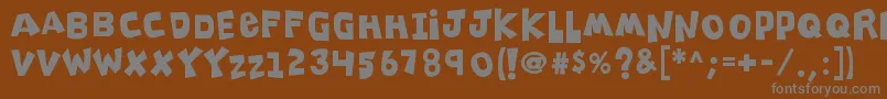 K26clippitysnippity-Schriftart – Graue Schriften auf braunem Hintergrund