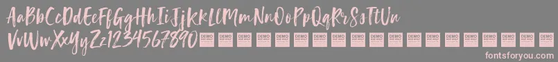 Fonte LuckyTurnsDemo – fontes rosa em um fundo cinza
