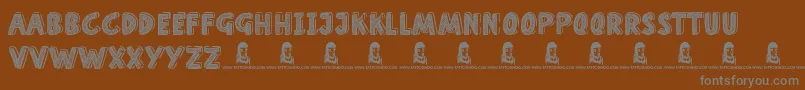 HomeSchool-fontti – harmaat kirjasimet ruskealla taustalla