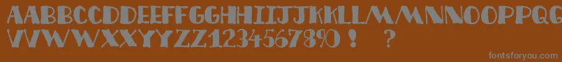 Decofree-fontti – harmaat kirjasimet ruskealla taustalla