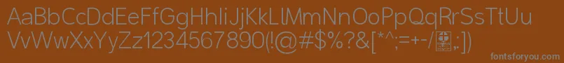 MalterSansLightDemo-fontti – harmaat kirjasimet ruskealla taustalla