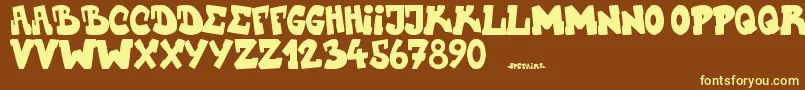 Upstairscvjmgraff-fontti – keltaiset fontit ruskealla taustalla