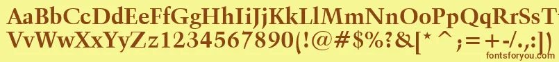フォントKuenstler480BoldBt – 茶色の文字が黄色の背景にあります。
