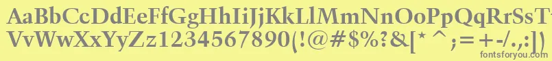 フォントKuenstler480BoldBt – 黄色の背景に灰色の文字