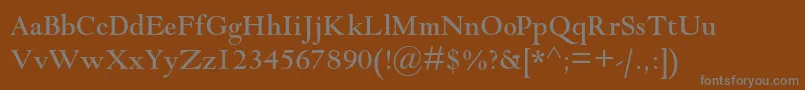 Goudymodernmtstd-fontti – harmaat kirjasimet ruskealla taustalla