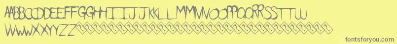 Dirtyfeature-fontti – harmaat kirjasimet keltaisella taustalla
