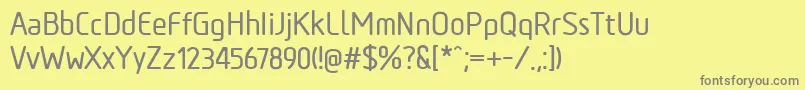 TadaoMedium-fontti – harmaat kirjasimet keltaisella taustalla