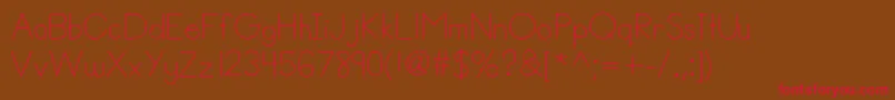 Helloannie-Schriftart – Rote Schriften auf braunem Hintergrund