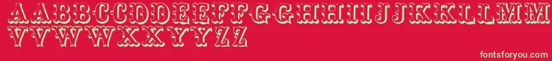 フォントToskanischeegyptienneinitialen – 赤い背景に緑の文字