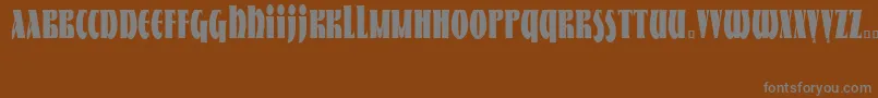NestorCondensed-fontti – harmaat kirjasimet ruskealla taustalla