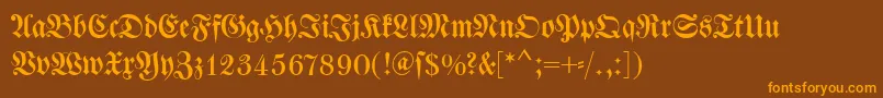 フォントDswalbaumfraktur – オレンジ色の文字が茶色の背景にあります。