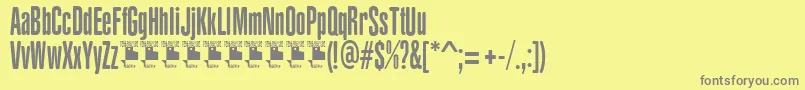 YacarenaUltraPersonalUse-fontti – harmaat kirjasimet keltaisella taustalla