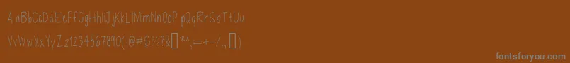 Czcionka Defenseless – szare czcionki na brązowym tle