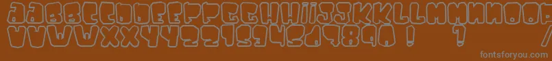 Ejaculator-fontti – harmaat kirjasimet ruskealla taustalla