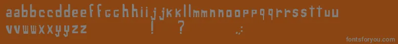 XiloSans-fontti – harmaat kirjasimet ruskealla taustalla