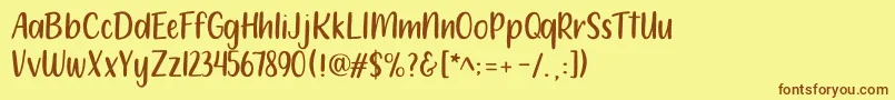 フォント212 Moon Child Sans – 茶色の文字が黄色の背景にあります。