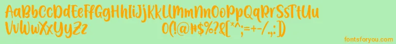 Czcionka A Calling Font D by 7NTypes – pomarańczowe czcionki na zielonym tle