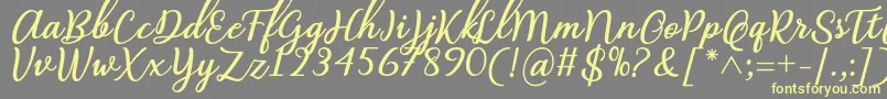 Abilya Regular Font by 7NTypes-fontti – keltaiset fontit harmaalla taustalla