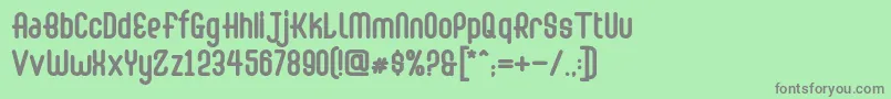 Abingdon Bold-fontti – harmaat kirjasimet vihreällä taustalla