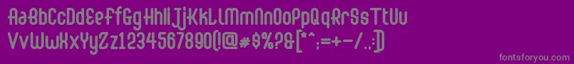 Abingdon Bold-fontti – harmaat kirjasimet violetilla taustalla
