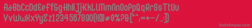 Abingdon Bold-fontti – harmaat kirjasimet punaisella taustalla