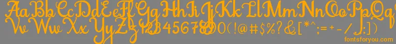 フォントAbiyells – オレンジの文字は灰色の背景にあります。