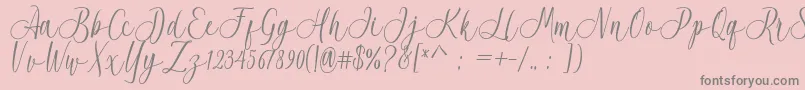 Acrobad-fontti – harmaat kirjasimet vaaleanpunaisella taustalla