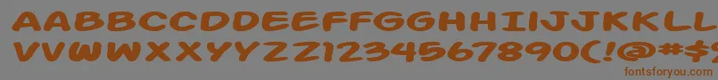 Action Man Extended Bold-Schriftart – Braune Schriften auf grauem Hintergrund