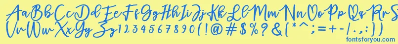 フォントadamd – 青い文字が黄色の背景にあります。