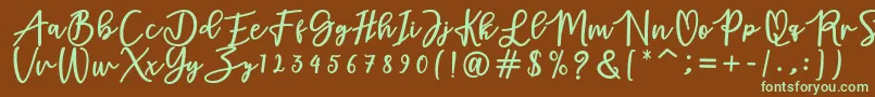 フォントadamd – 緑色の文字が茶色の背景にあります。