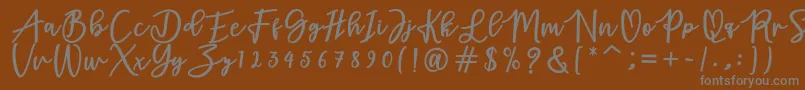 フォントadamd – 茶色の背景に灰色の文字