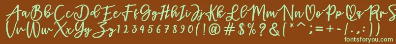 フォントadamd – 緑色の文字が茶色の背景にあります。