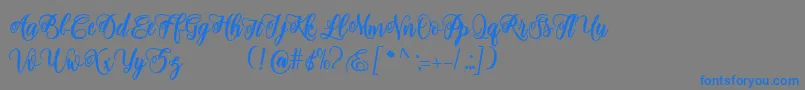 adinda script-Schriftart – Blaue Schriften auf grauem Hintergrund